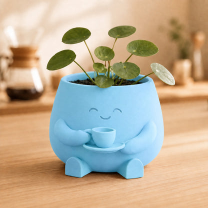 Vaso amiguinho segurando uma xícara com as duas mãos, na cor azul-celeste