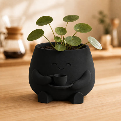 Vaso amiguinho segurando uma xícara com as duas mãos, na cor preta