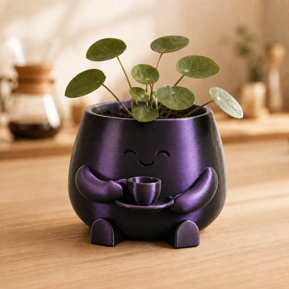 Vaso amiguinho segurando uma xícara com as duas mãos, na cor preta e roxa