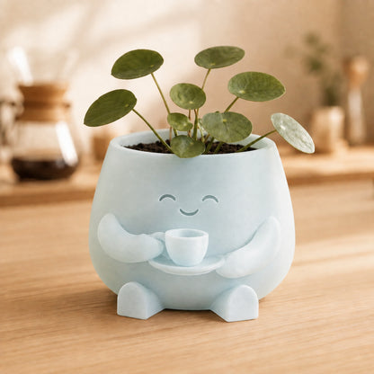 Vaso amiguinho segurando uma xícara com as duas mãos, na cor translúcida