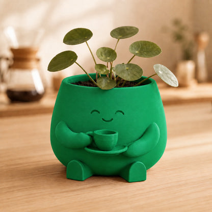 Vaso amiguinho segurando uma xícara com as duas mãos, na cor verde