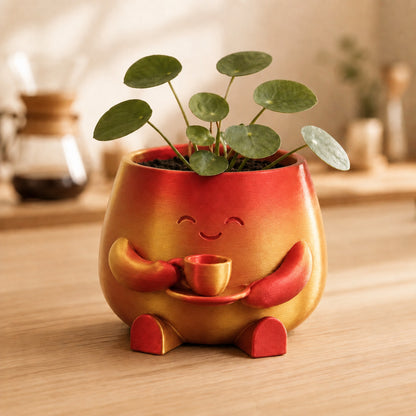 Vaso amiguinho segurando uma xícara com as duas mãos, na cor vermelha e dourada