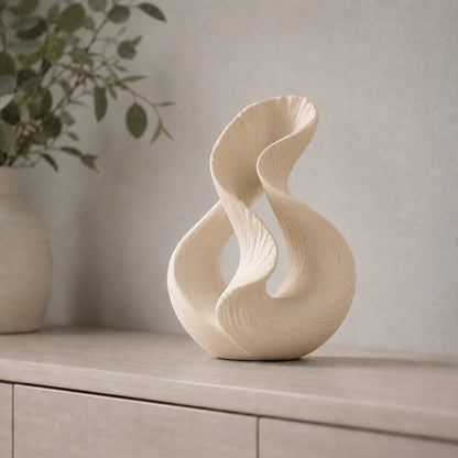 Escultura decorativa com duas curvas entrelaçadas, na cor bege